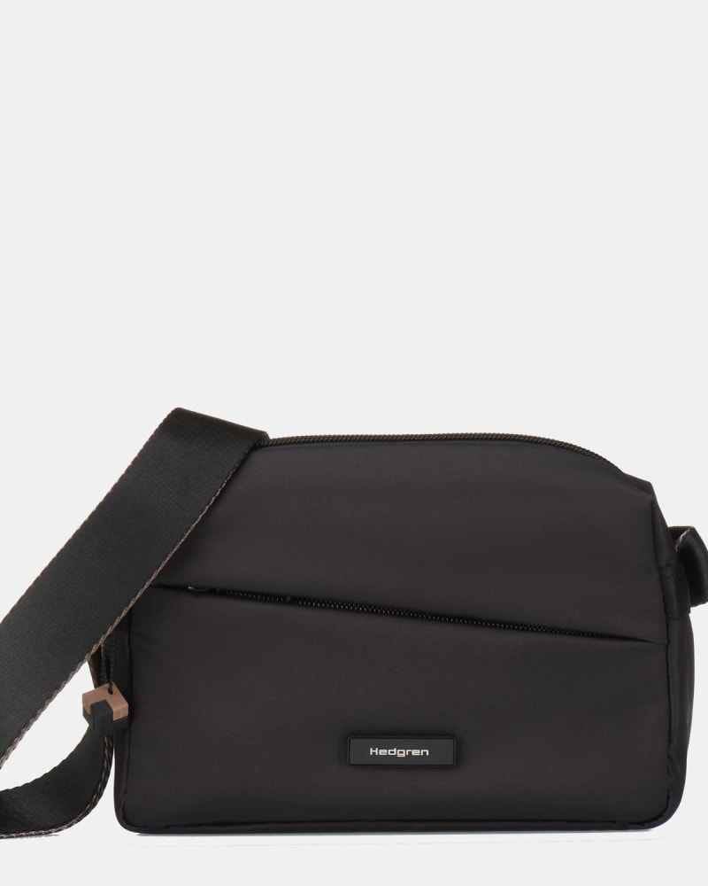 Front of a model wearing a size O/S Neutron Small Crossbody In Black in Black by Hedgren. | dia_product_style_image_id:357586